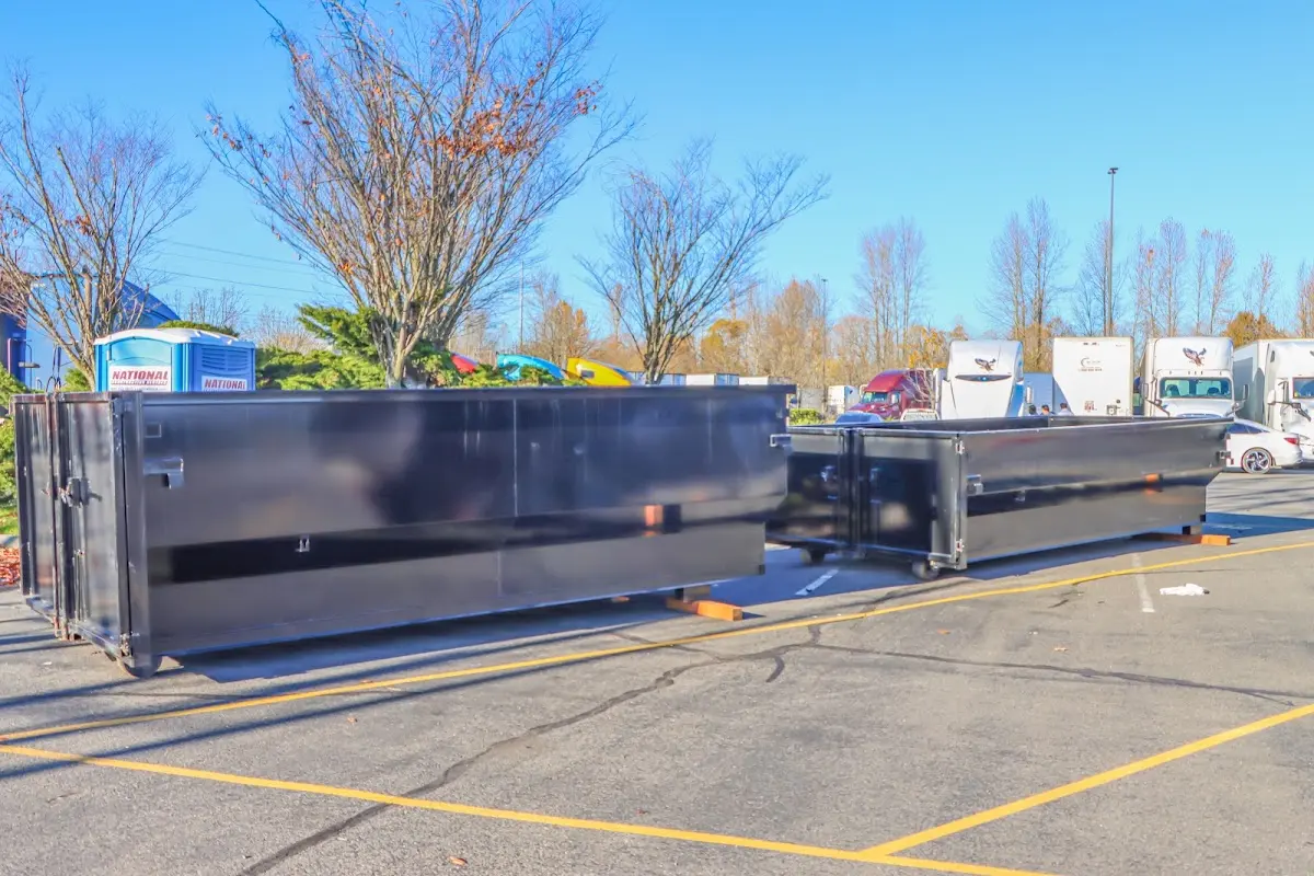 Professional dumpster rental service with roll-off container on residential driveway in Del Rio